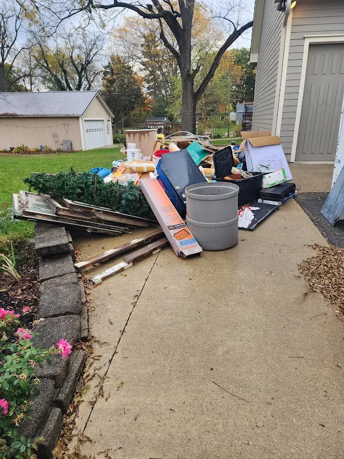 Dumpster being loaded with debris for Commercial Dumpster Rental in Weehawken